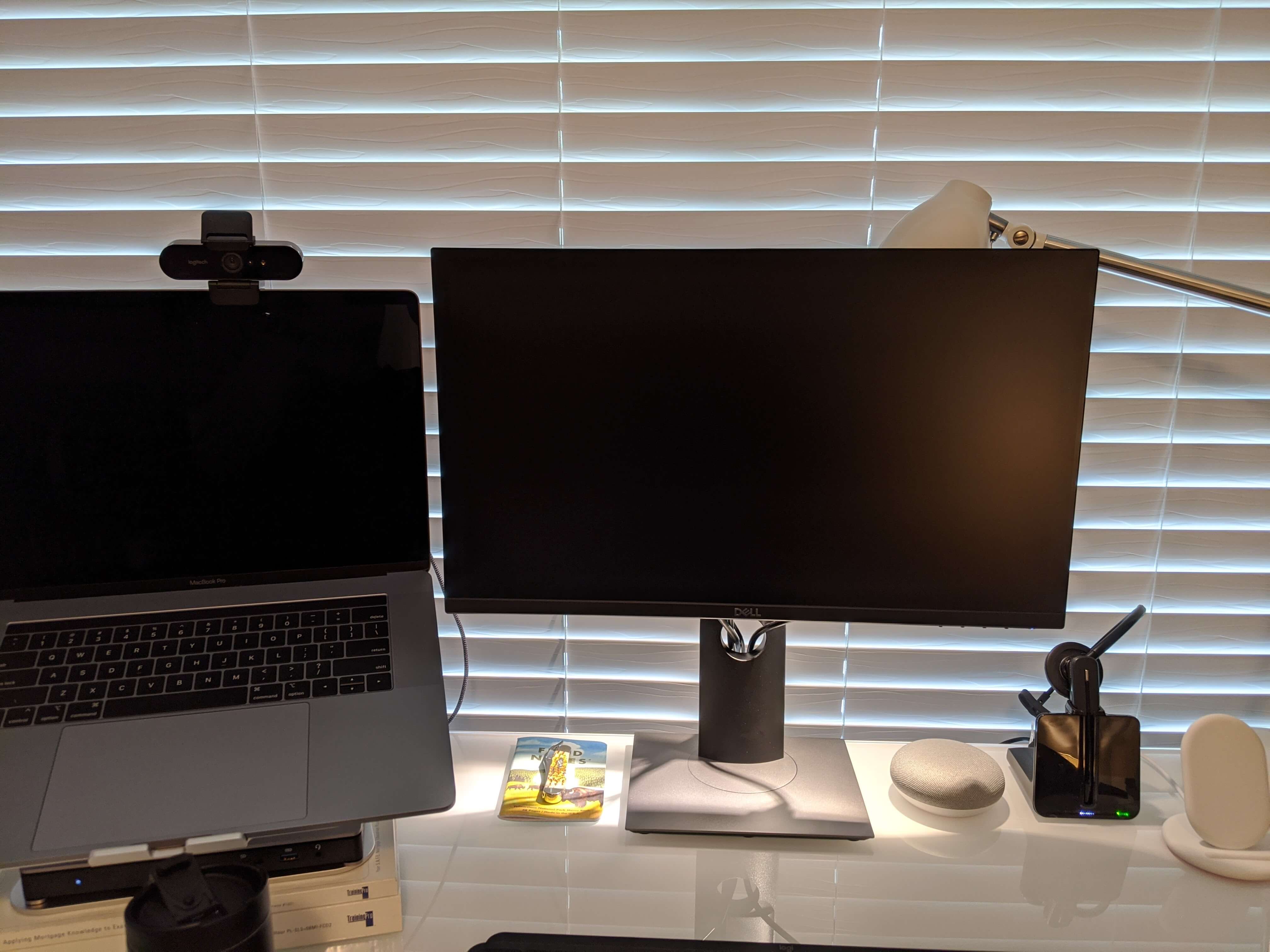 A picture of computer monitors with a lamp placed behind them