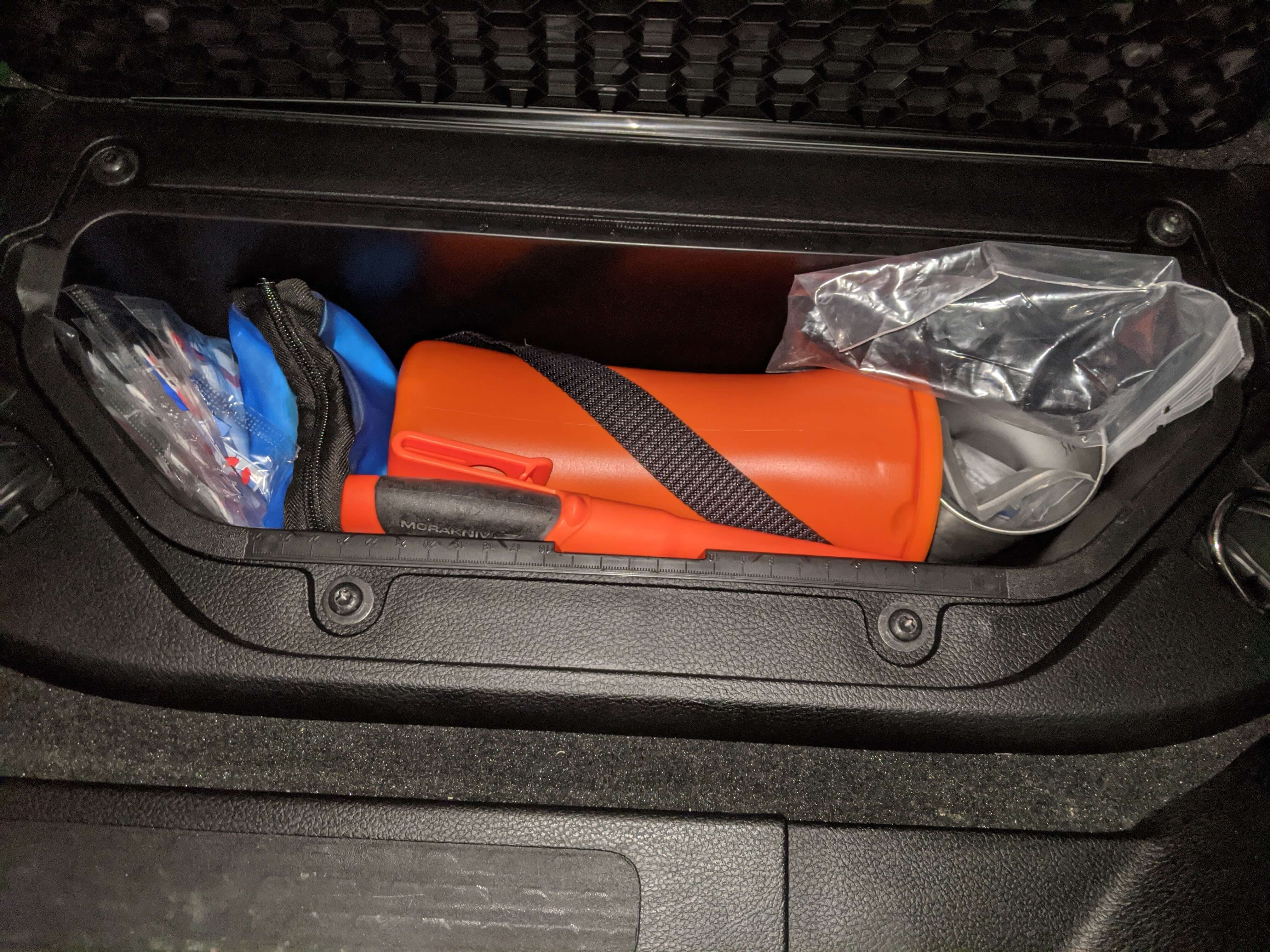 survival kit stored in compartment